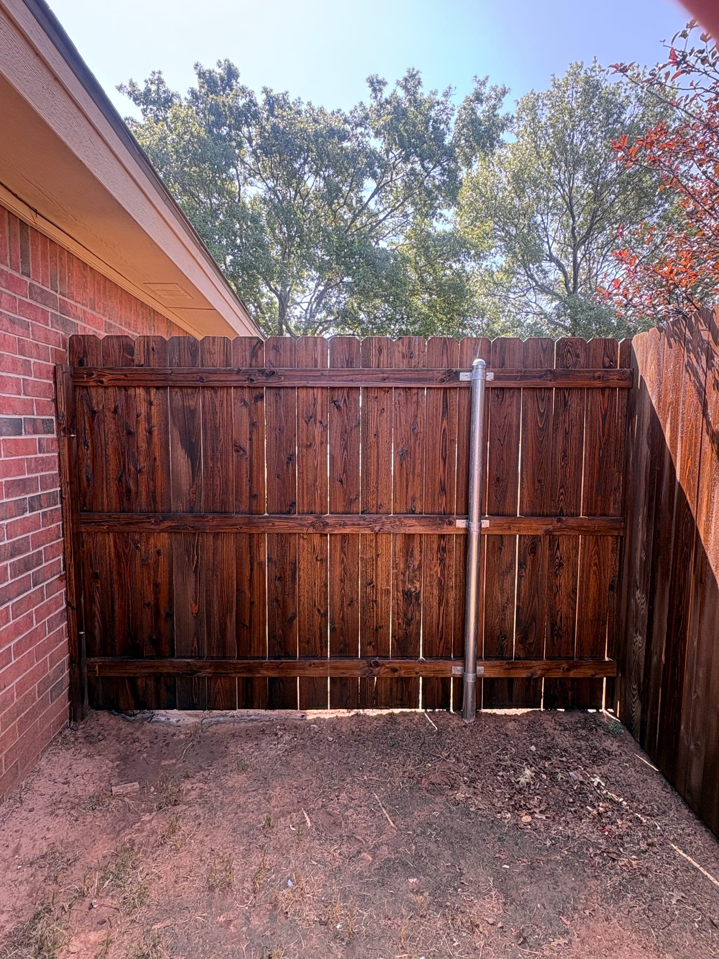Freshly stained wood fence gate.