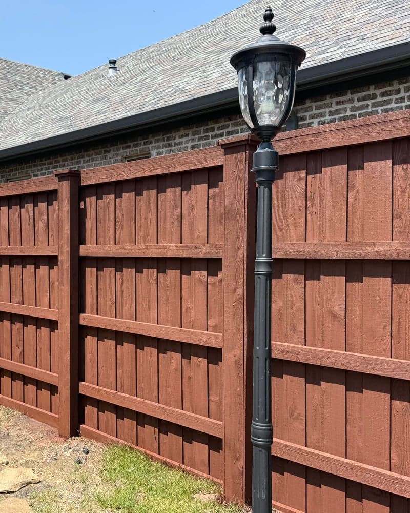 The same side-yard fence after staining